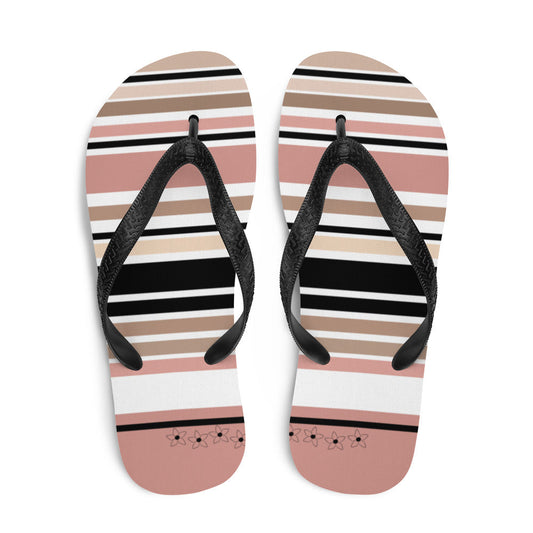 Gestreifte Flip-Flops mit Blumendetail in Beige, Schwarz und Creme. Strandschuhe